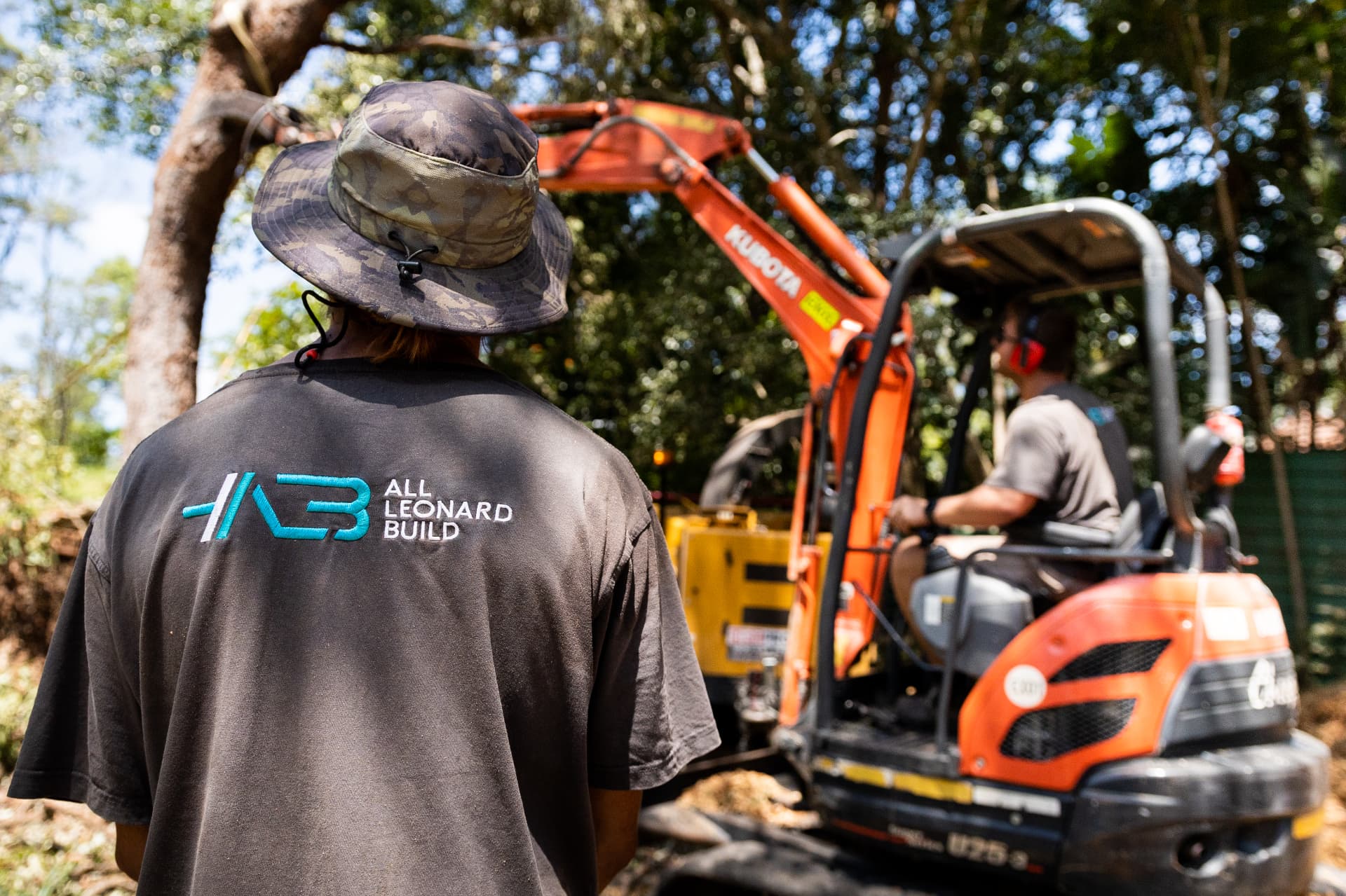 All Leonard Build team on site with excavator at the Treehouse project.